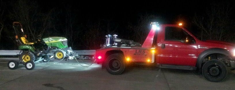 LRS recovery truck transporting a riding lawnmower recovered in Kearney