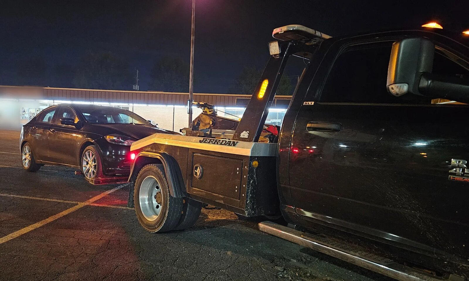LRS self-loading recovery truck with a passenger car recovered in Kearney at night