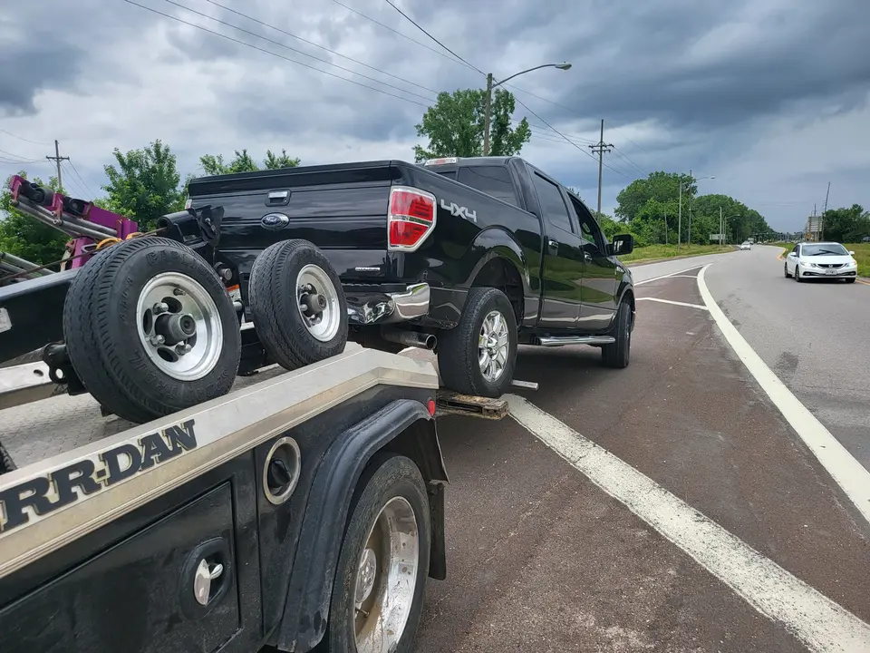 Black Ford F-150 secured by LRS equipment during a documented Overland Park repossession